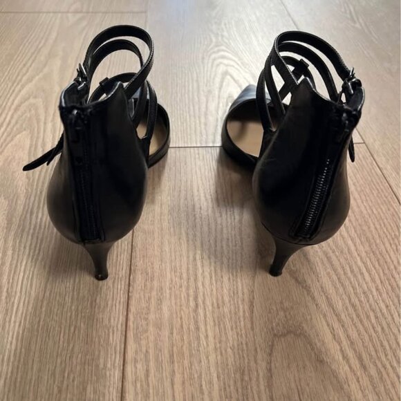 This is a pair of black pointed-toe stiletto heels. - Picture 2 of 3